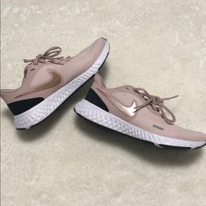 Pink Nike Revolution 5 athletic shoes